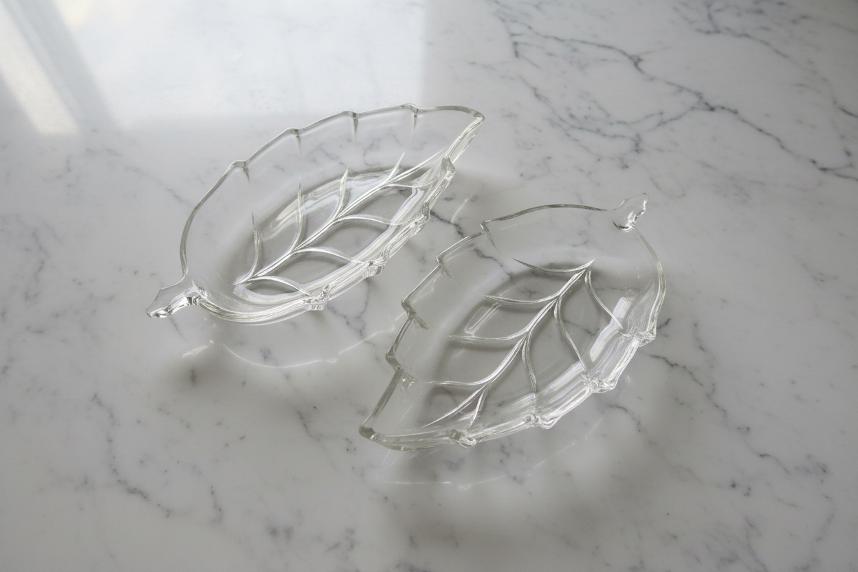 Clear glass leaf dishes set of 2 on white marble background